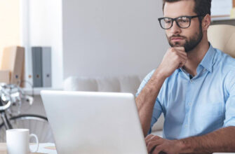 Фото серьезный мужчина в очках работает за ноутбуком